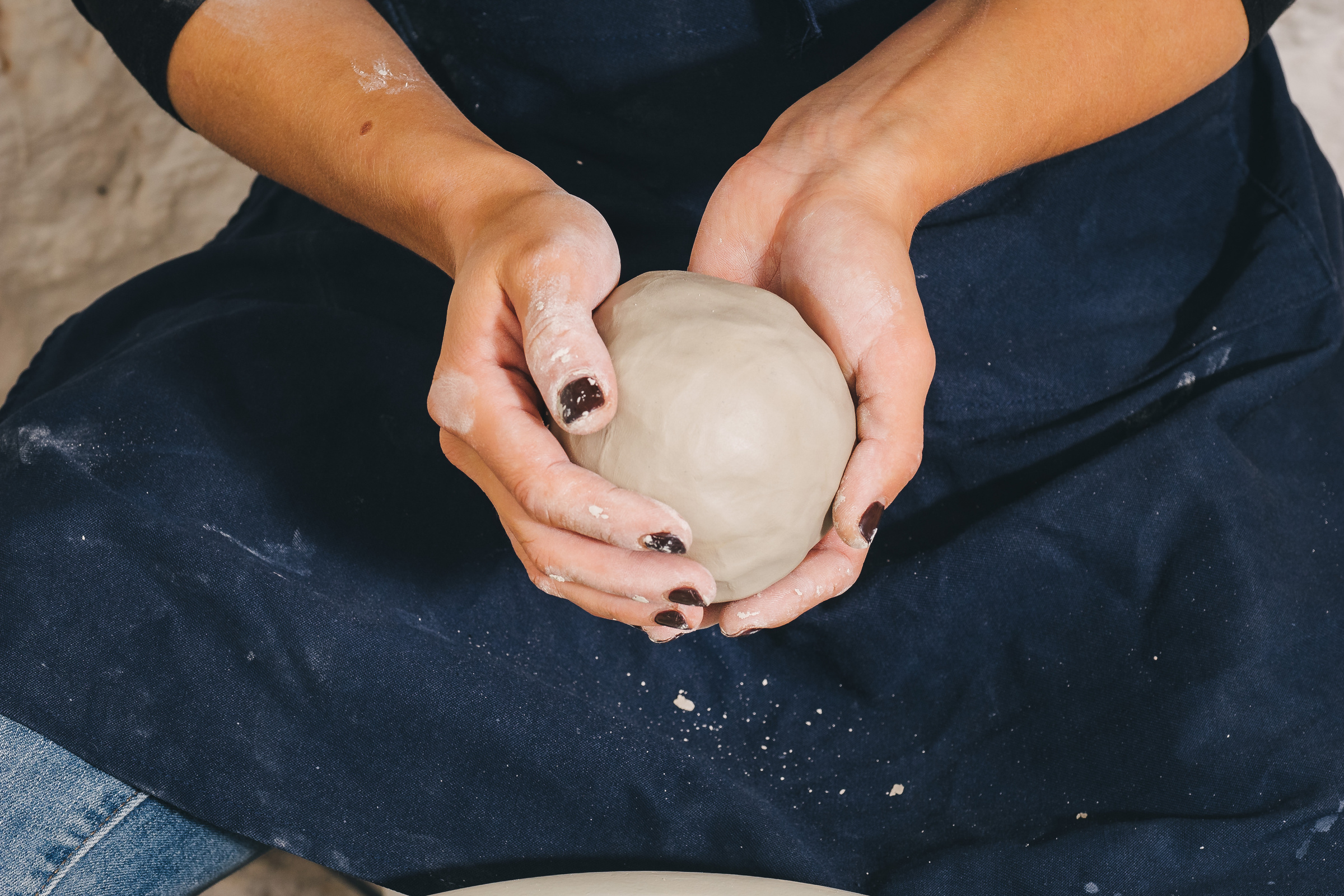 Hands working on pottery wheel